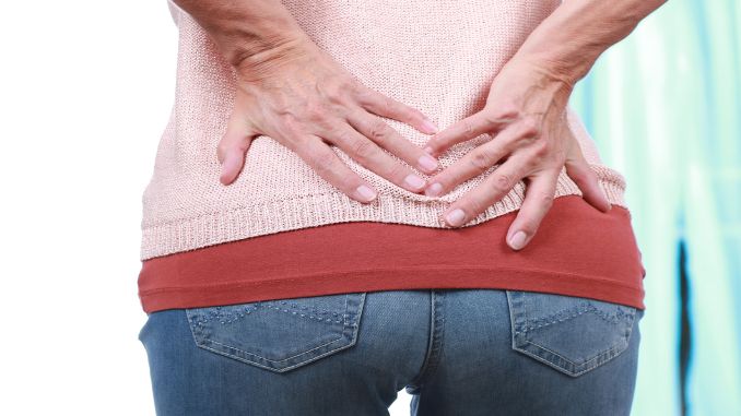 Mature woman with back pain - spinal fusion surgery recovery