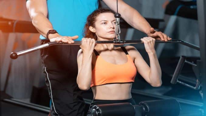 sporty female exercising pulldown