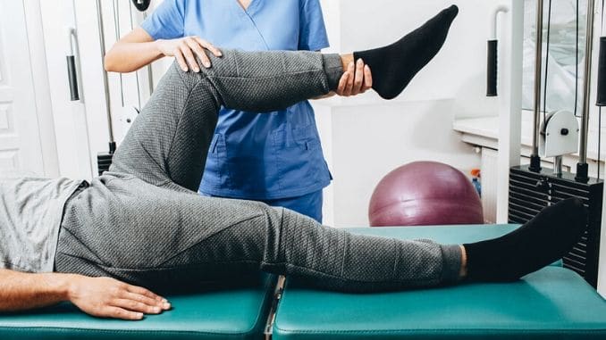 physiotherapist doing treatment exercise patients knee