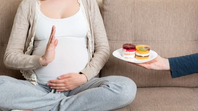 pregnant woman sitting on the sofa