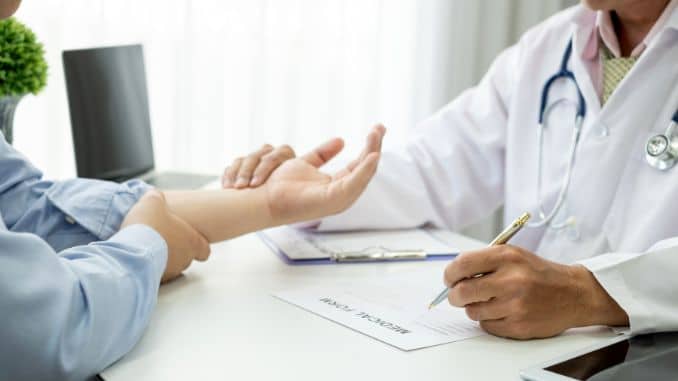 examining--patient--wrist-pain