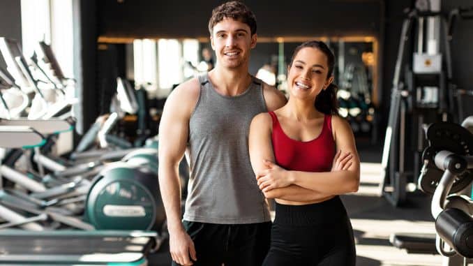 couple-standing-modern-gym
