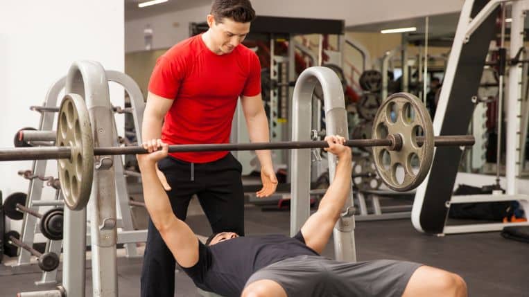 man-spotting-friend-bench-press